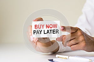 Phrase BUY NOW PAY LATER written on a white paper card