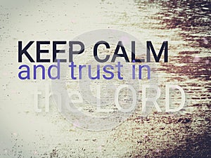 Short message saying Keep calm and trust in the Lord.  Text on wood background saying keep calm and trust in the Lord.