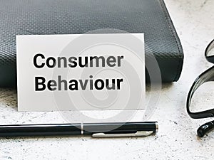 Phrase consumer behaviour on white card.