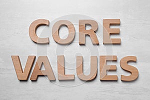 Phrase CORE VALUES made of wooden letters on white background, flat lay