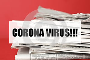 Phrase Corona Virus and stack of newspapers on background, closeup. Journalist`s work