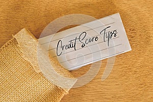 Phrase CREDIT SCORE TIPS written on white paper. Financial concept