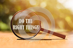 The phrase Do The Right Things typed on a magnifier glass. A reminder to make the right choices according to your moral compass