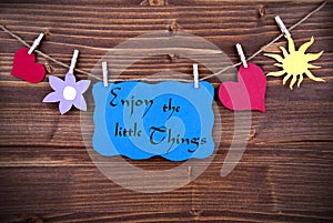 The Phrase Enjoy The Little Things On A Blue Label