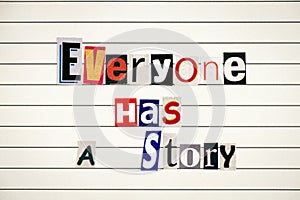 Phrase Everyone Has a Story made from letters cutting from magazines photo