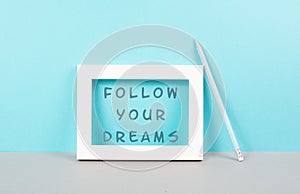 The phrase follow your dreams is standing in the frame, choaching concept, positive and optimistic thinking, having a goal