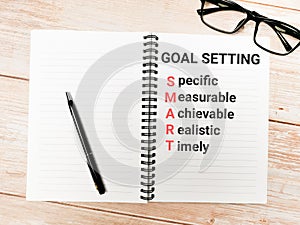 Phrase goal setting on note book.