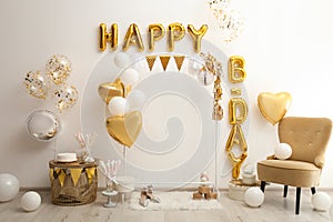 Phrase HAPPY BIRTHDAY made of balloon letters in decorated room