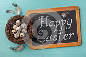 Phrase Happy Esther on chalkboard and nest with eggs