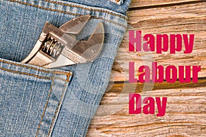 Phrase HAPPY LABOUR DAY written on wooden background