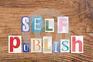 Phrase `Self publish` in cut out magazine letters photo