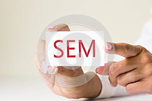 Phrase SEM - search engine marketing - written on a white paper card