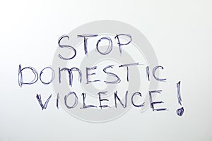 Phrase STOP DOMESTIC VIOLENCE on background, top view