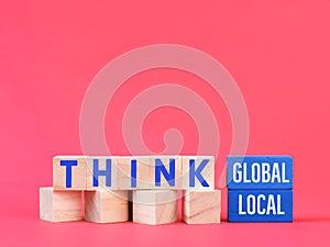 Phrase think global or local on wooden blocks.