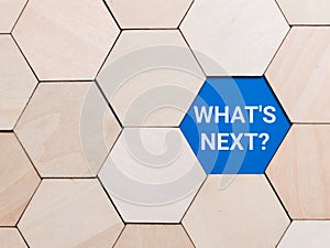 Phrase whats next on wooden hexagon. Business step concept.