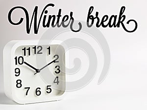 Phrase Winter break with alarm clock isolated on white background.