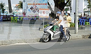 Phu Quoc, Vietnam - circa february 2024: family transport on a motorbike photo