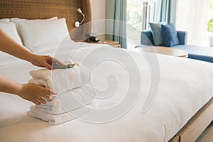 PHU QUOC, VIETNAM JUNE 28, 2017: Cropped image of a female chambermaid making bed in hotel room