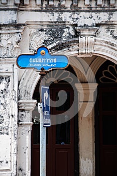 Phuket street sign and old Sino Portuguese house classic facade with stuccowork in Phuket Old town area. Thailand