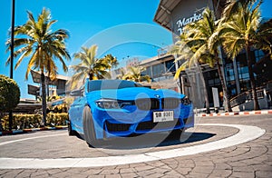 PHUKET, THAILAND- DECEMBER 25, 2023: Beautiful bright blue BMW M3 series in the parking lot.