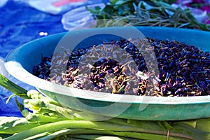 Phuket, Thailand food market: blue bowl holding lemongrass-flavoured crickets photo