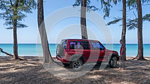 Phuket Thailand on January 20-2022 Young Asian male traveler and photographer standing on the car 4x4 car and Taking photo sea bea