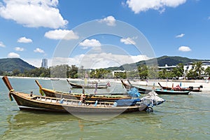 Phuket, Thailand, Patong Beach, 04/19/2019: looking over the sea towards a mainland with fishing boat in foreground