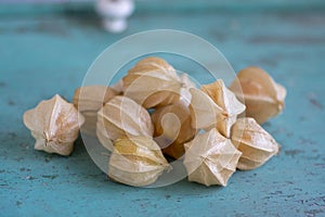 Physalis peruviana ripened orange yellow cape gooseberry goldenberry edible tasty ingredient fruits spread on wooden background