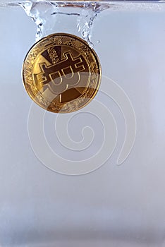 Physical bitcoin dropped in water