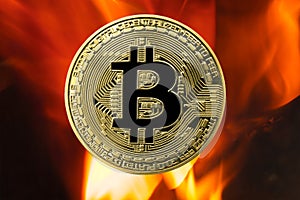 Physical Bitcoin gold coin BTC with fire or flame background