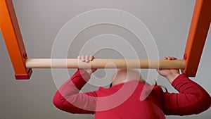 Physical development children sport education. Child workout home fit. Strong kid pull up bar exercise on gymnastic bar