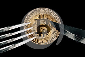 Physical Golden Crytocurrency Coin under fork and knive.