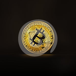 Physical shiny bitcoin agains dark background