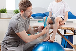 Physical therapist applying medical tape