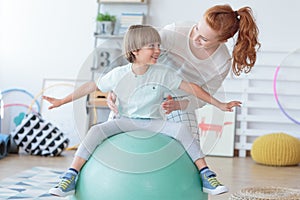 Physical therapist assisting little boy