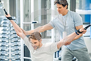 Physical therapist assisting a patient while exercising on hyperextension