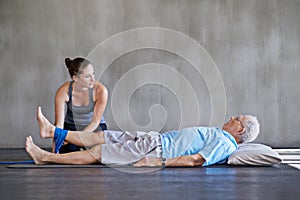 Physical therapist, legs and elderly man patient with physiotherapy exercise at rehabilitation center. Consultation