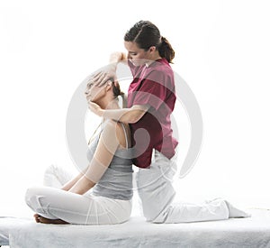 Physical therapist makes a cervical evaluation to woman