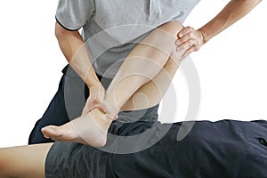 Physical therapist treats knee and leg to the patient on white background.