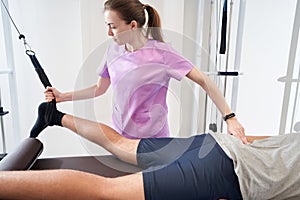 Physical therapist working with patient in rehabilitation clinic