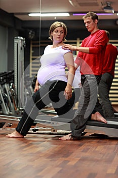 Physical therapist working with pregnant woman