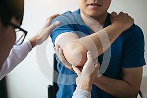 Physical therapists are checking patients elbows at the clinic office room photo