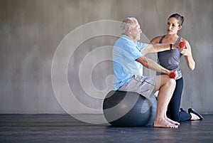 Physical therapy, dumbbells and senior man on ball for fitness, rehabilitation or exercise at gym on mockup. Elderly