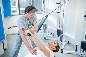 Physical therpaist working with the patient in a rehabilitation center