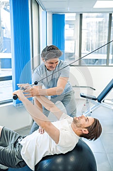 Physical therpaist working with the patient in a rehabilitation center