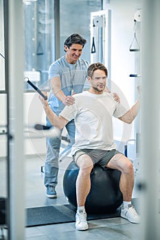 Physical therpaist working with the patient in a rehabilitation center