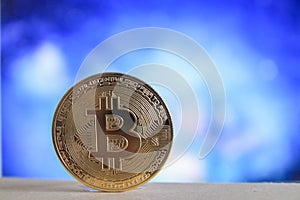 A physical version of Bitcoin BTC with blurred blue background
