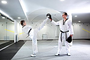 Physically challenged girl in martial arts training taekwondo photo