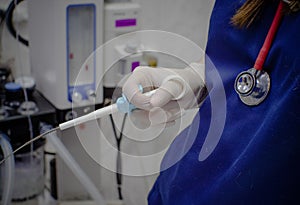 Physician assistant holding biopsy clamp during endoscopy. A patient with complaints of pain in the stomach undergoes an