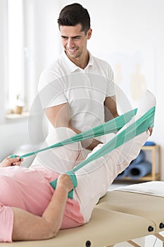 Physician assisting woman in physiotherapy